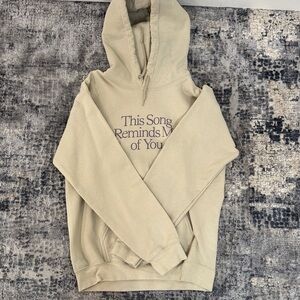 LONELY GHOST Cream Hoodie with Purple Text